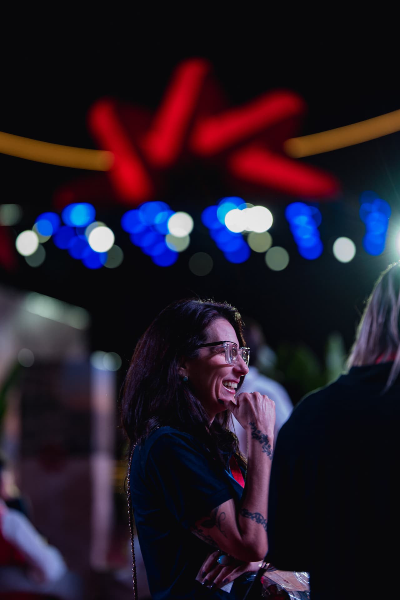 Convidada sorrindo em evento noturno